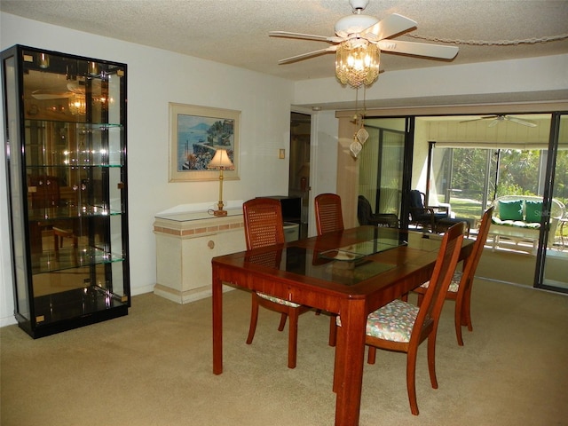 dining area with a ceiling fan, carpet, and a textured ceiling