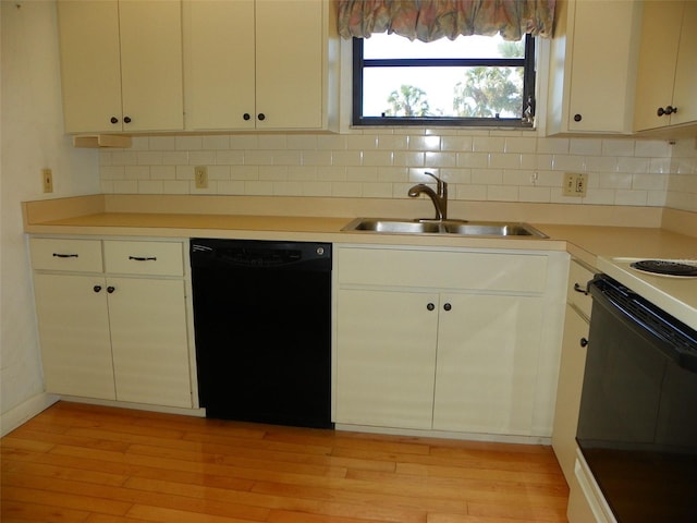 kitchen featuring electric range oven, a sink, light wood-type flooring, backsplash, and dishwasher