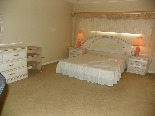 bedroom featuring light carpet and baseboards