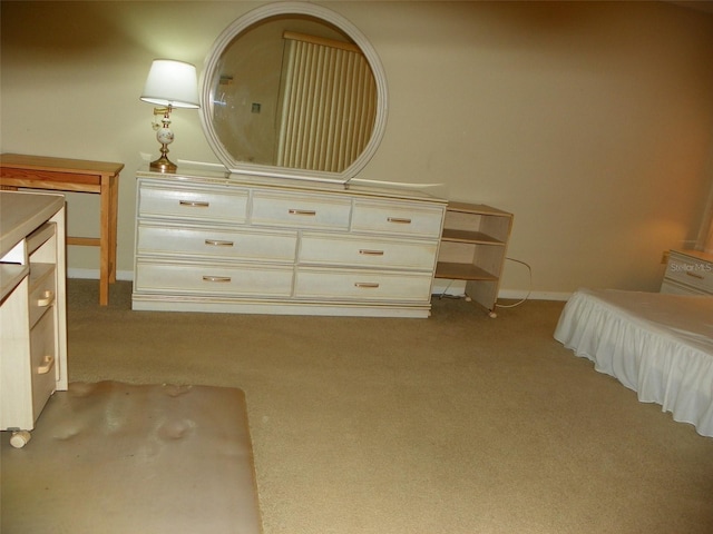 bedroom featuring baseboards and light colored carpet