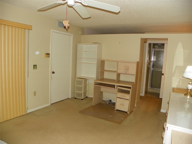 unfurnished bedroom with light carpet, a ceiling fan, visible vents, and a textured ceiling