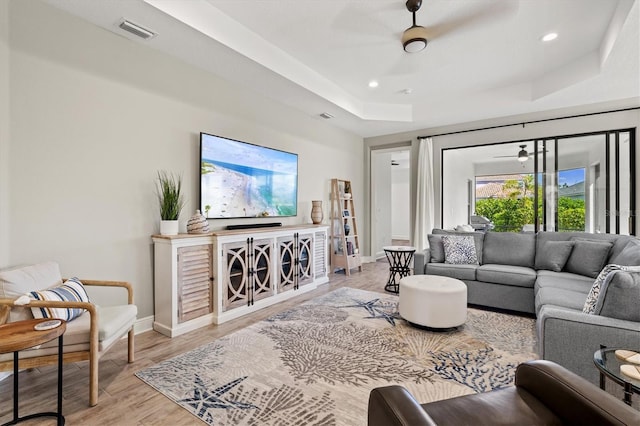 2720 Butterfly Jasmine Trl, Sarasota, FL 34240 - living area featuring a raised ceiling, baseboards, light wood finished floors, and recessed lighting