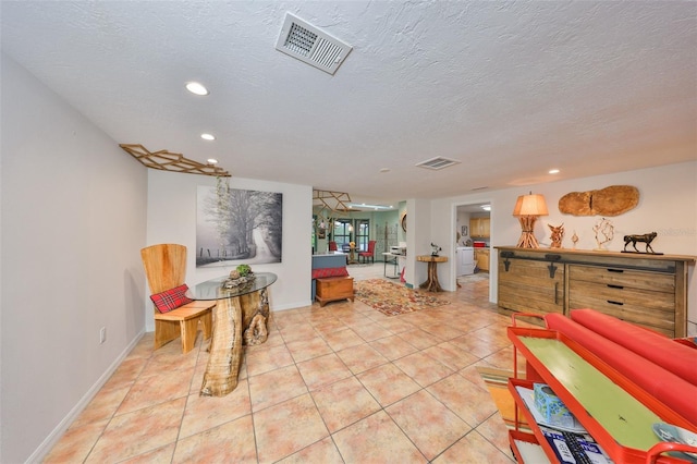 sitting room with a textured ceiling, tile patterned flooring, visible vents, and recessed lighting