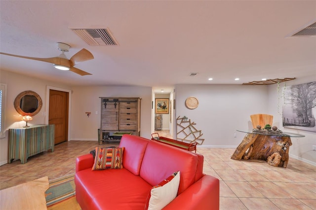 living room featuring light tile patterned floors, baseboards, visible vents, and a ceiling fan