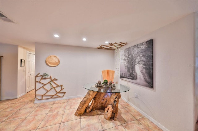 interior space featuring visible vents, baseboards, and light tile patterned floors