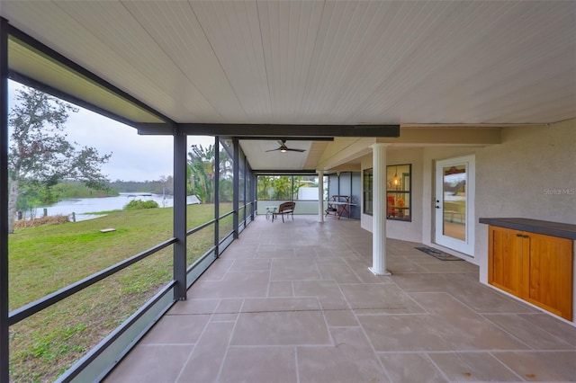 unfurnished sunroom with a water view