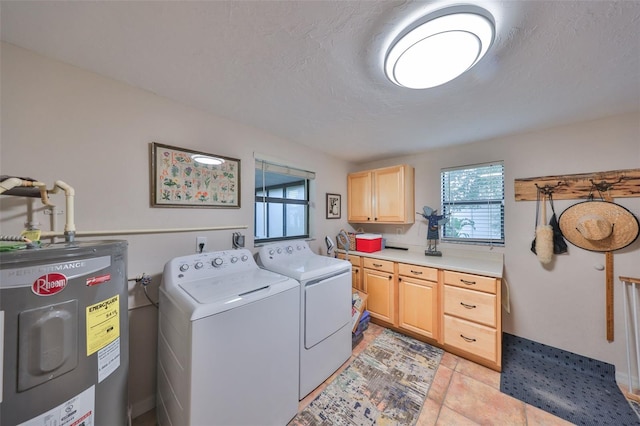 laundry area with washing machine and dryer, electric water heater, cabinet space, and a textured ceiling