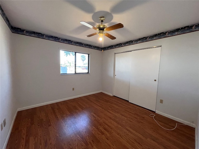 unfurnished bedroom with a ceiling fan, a closet, baseboards, and wood finished floors