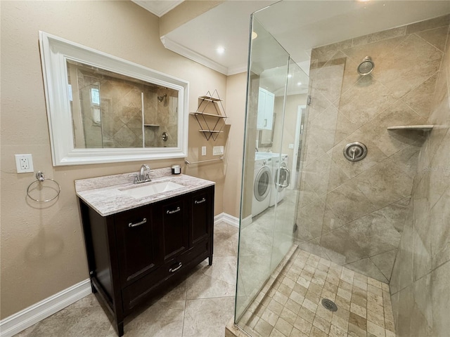 full bath with separate washer and dryer, vanity, baseboards, a shower stall, and crown molding