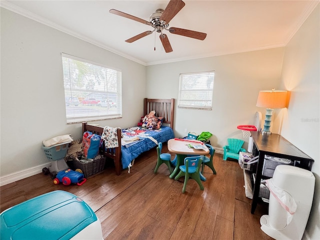 bedroom featuring baseboards, multiple windows, ornamental molding, and wood finished floors