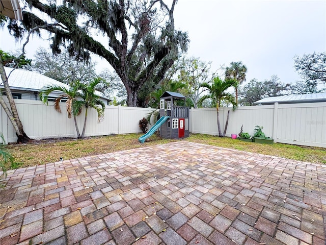 view of patio / terrace with a playground and a fenced backyard