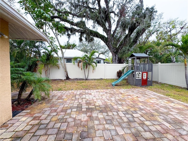 view of patio / terrace featuring a fenced backyard and a playground