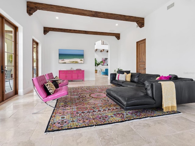 living area featuring visible vents, beamed ceiling, and recessed lighting