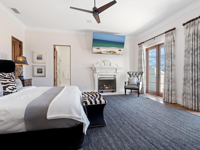 bedroom with a warm lit fireplace, visible vents, access to exterior, crown molding, and french doors