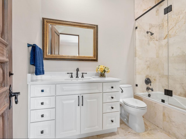 full bathroom featuring tiled shower / bath, vanity, and toilet