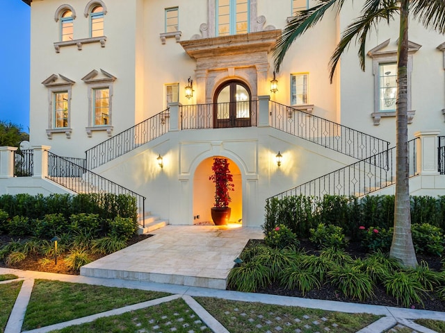 property entrance with stucco siding