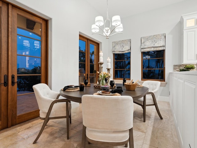 dining area with baseboards and a notable chandelier