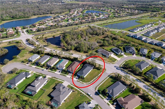 drone / aerial view featuring a water view and a residential view