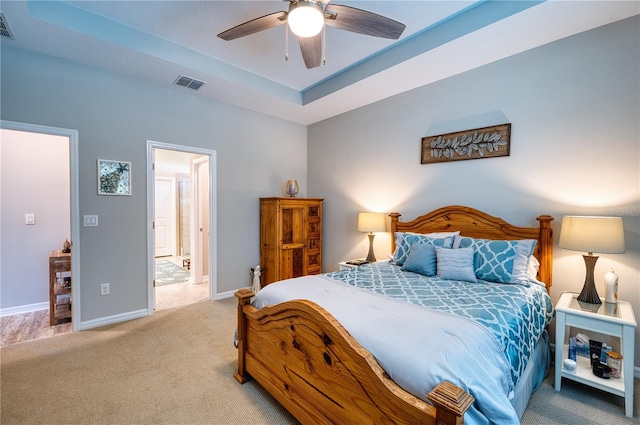 bedroom with baseboards, visible vents, a raised ceiling, and carpet flooring