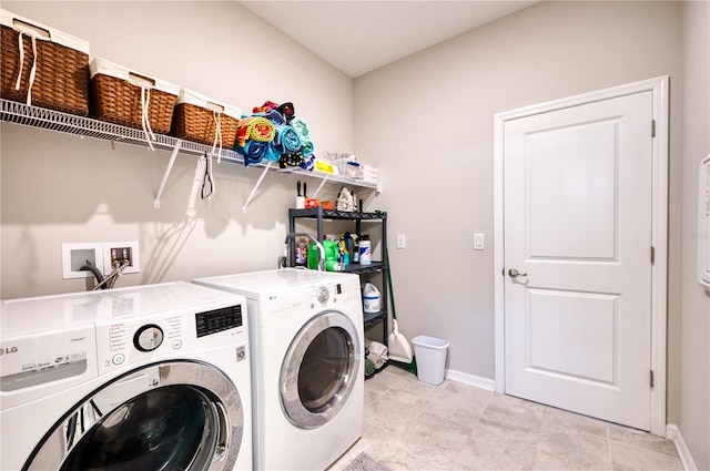 laundry room featuring laundry area, separate washer and dryer, and baseboards