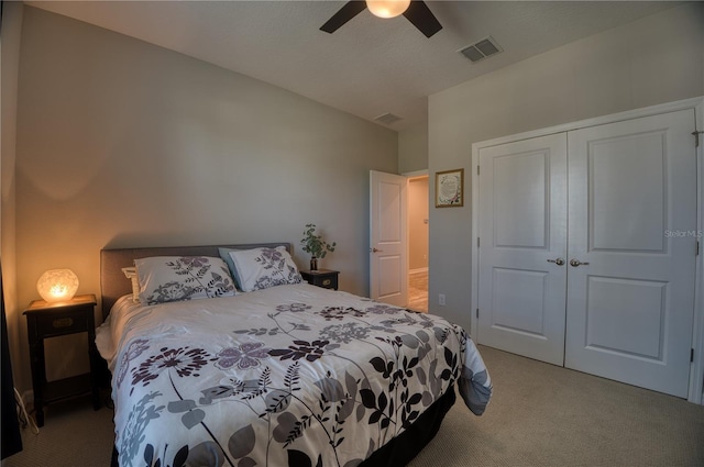 bedroom with ceiling fan, carpet floors, visible vents, vaulted ceiling, and a closet