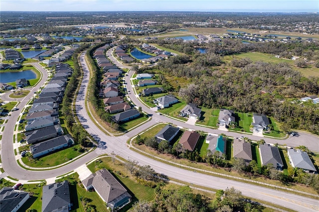 bird's eye view with a residential view and a water view