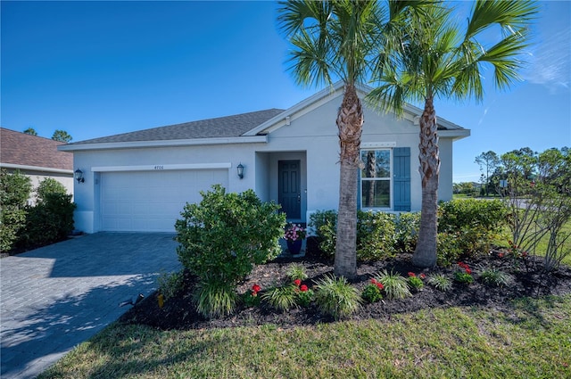 view of front of home with a garage, a shingled roof, decorative driveway, and stucco siding