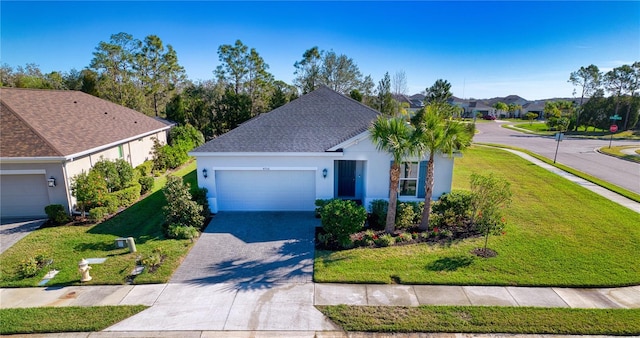 single story home with roof with shingles, an attached garage, decorative driveway, a front yard, and stucco siding