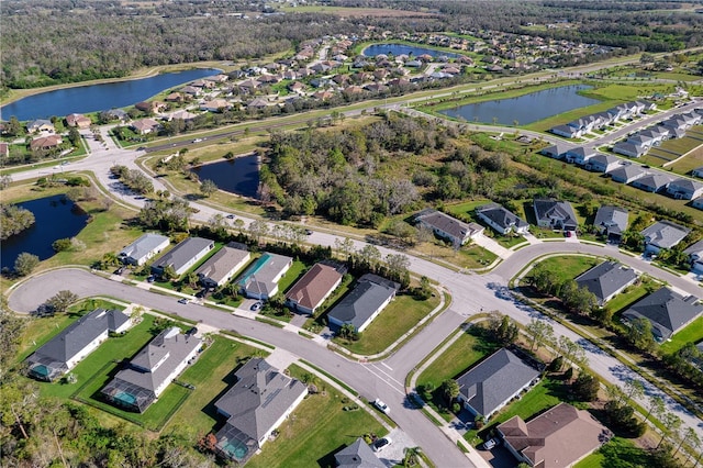 drone / aerial view featuring a residential view and a water view