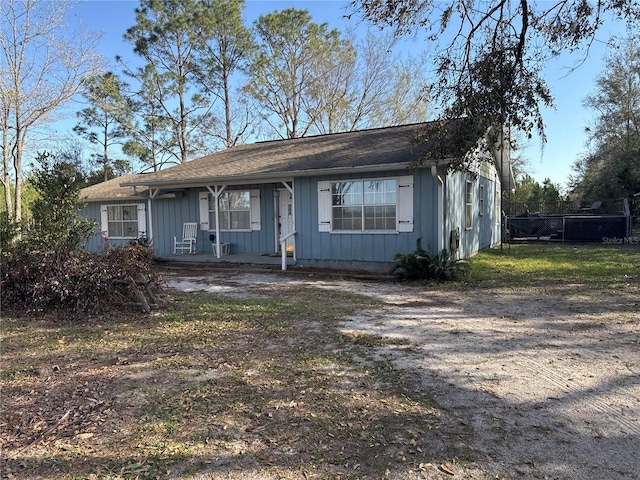 view of front of property with covered porch, board and batten siding, and driveway