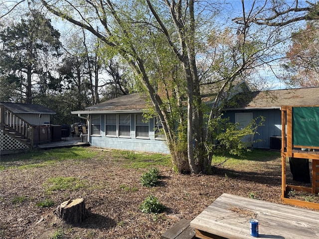 view of yard with a sunroom and a wooden deck