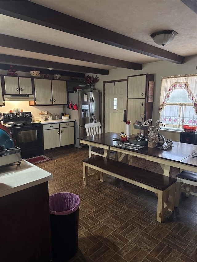 dining room with beamed ceiling and brick floor