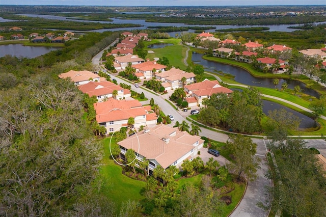 drone / aerial view featuring a water view and a residential view