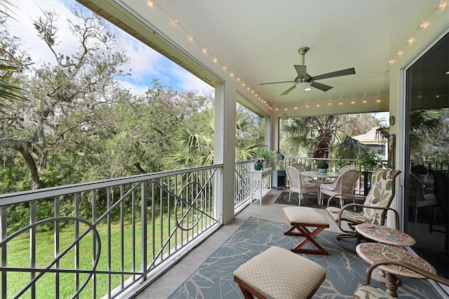 balcony with a ceiling fan and a sunroom