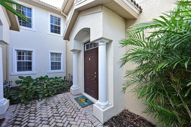 entrance to property with stucco siding