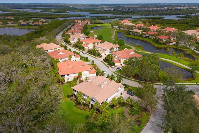 birds eye view of property with a water view and a residential view