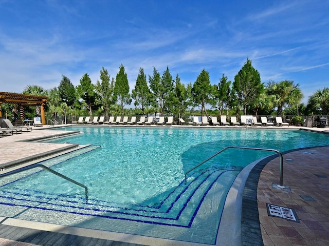 pool with fence and a patio