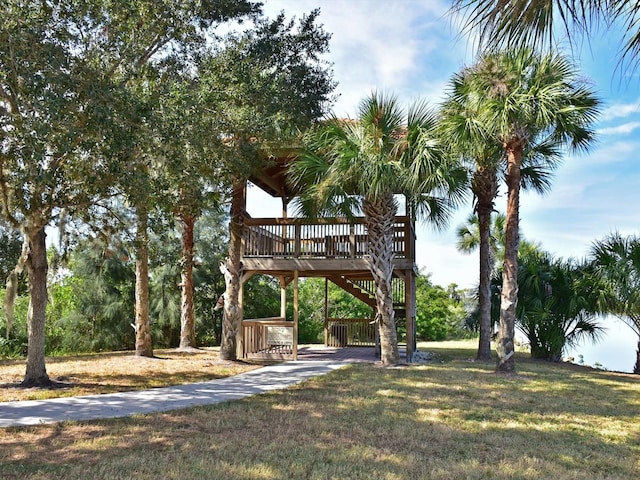 view of community featuring driveway and a yard