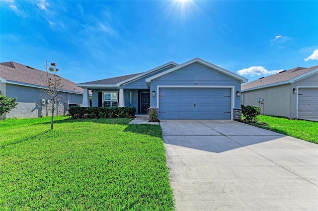 ranch-style house featuring an attached garage, driveway, and a front lawn