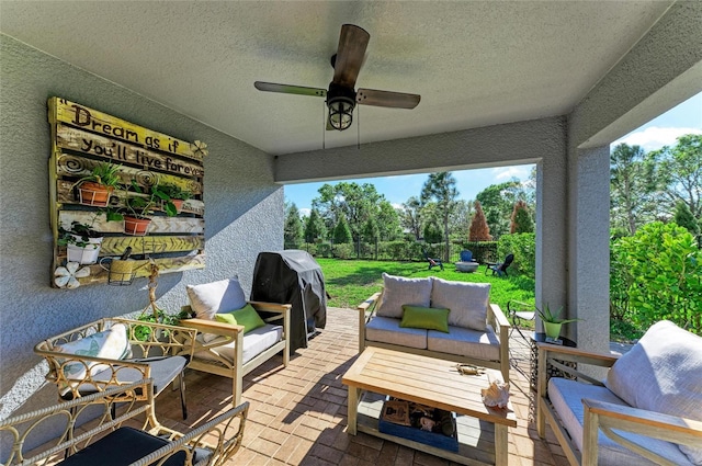 wooden terrace featuring a ceiling fan, a patio, an outdoor living space, and grilling area