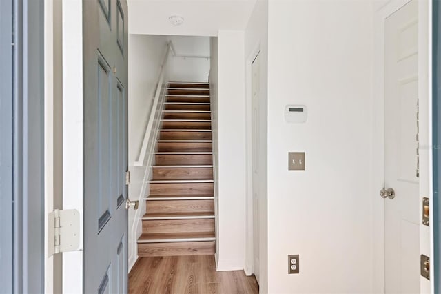 stairway with wood finished floors