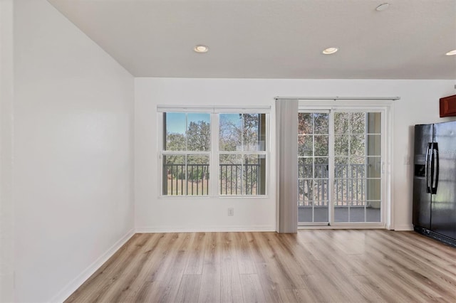 interior space featuring recessed lighting, baseboards, and light wood finished floors