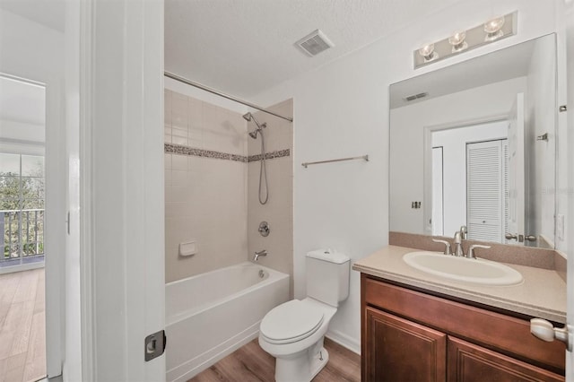 bathroom featuring toilet, visible vents, a closet, and vanity