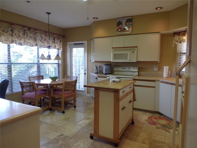 kitchen featuring white cabinets, white appliances, and wooden counters