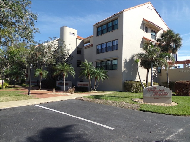 view of building exterior featuring uncovered parking