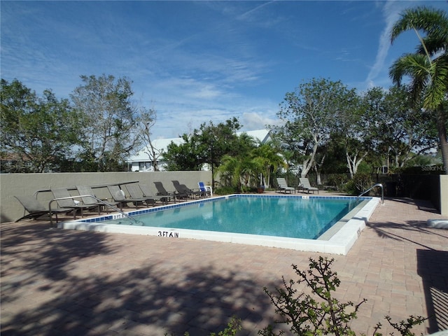 pool featuring a patio and fence