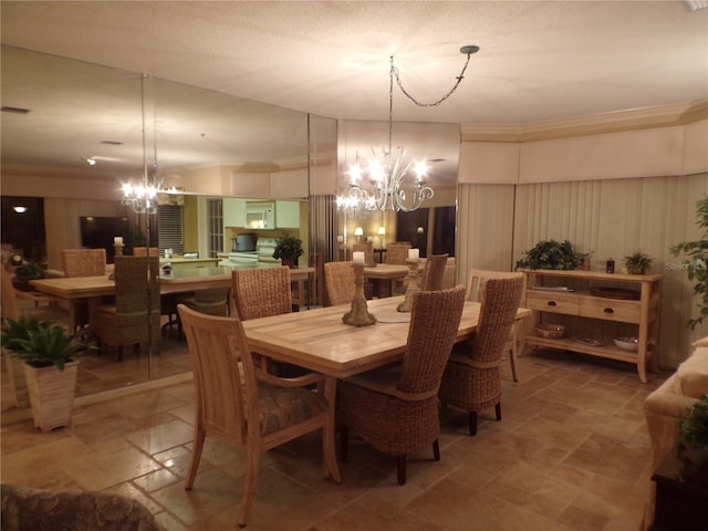 dining room featuring stone finish floor and a notable chandelier