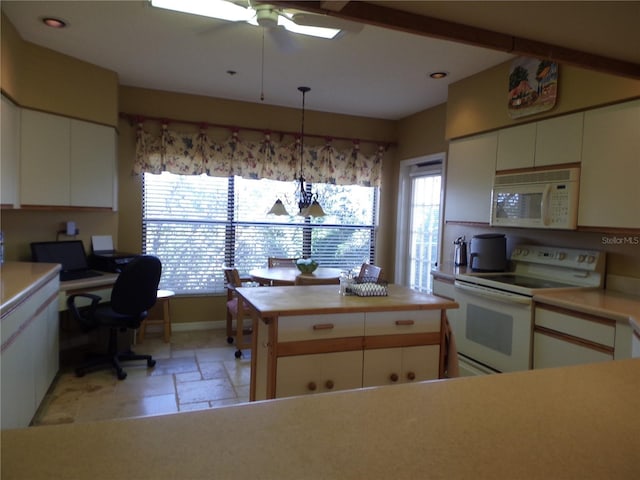 kitchen with light countertops, white appliances, white cabinetry, and stone tile floors