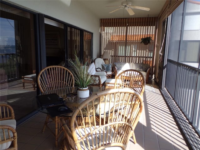 sunroom / solarium featuring ceiling fan