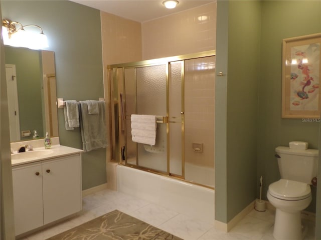 bathroom with toilet, combined bath / shower with glass door, vanity, baseboards, and tile patterned floors